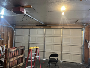 An interior view of a garage showing a newly installed garage door and opener system by J&S Garage Door Services in Franklin, TN.