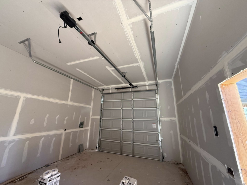 A garage door and opener system installed in a new construction garage by Rhino Garage Doors LLC OKC in Edmond, OK.
