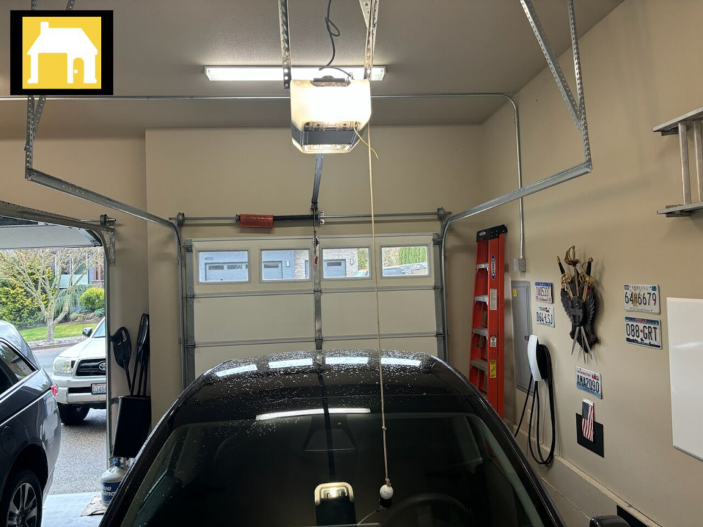 Interior view of a garage showing a newly installed garage door opener and the garage door, by TH Locksmith And Garage Door Repair, Vancouver, WA.