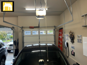 Interior view of a garage showing a newly installed garage door opener and the garage door, by TH Locksmith And Garage Door Repair, Vancouver, WA.