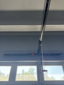 Close-up of a garage door opener rail and torsion spring system by AAA Garage Door Services in Renton, WA