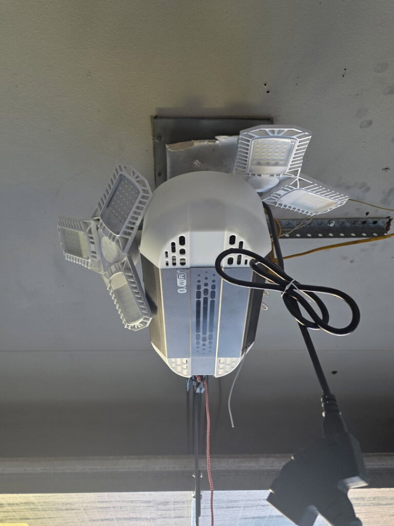 A modern garage door opener with an integrated LED light fixture, installed by Legacy Garage Doors & Repairs in Church Point, LA.
