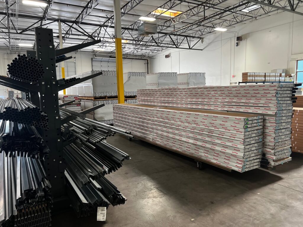 Garage door panels and metal tracks stored in a warehouse, indicating materials used by Overhead Door Company of Maricopa & Pinal County in Mesa, AZ.