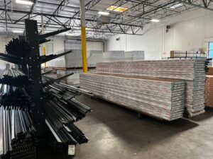Garage door panels and metal tracks stored in a warehouse, indicating materials used by Overhead Door Company of Maricopa & Pinal County in Mesa, AZ.