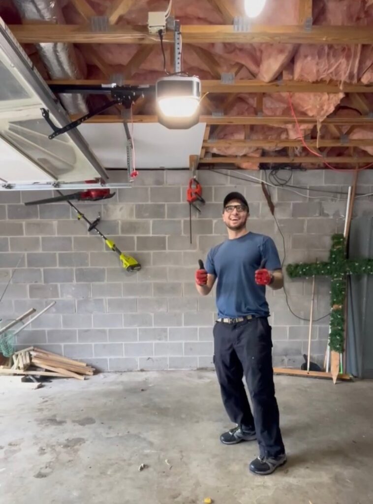 A garage interior showing a white garage door, ladder, and tools, indicating a repair or installation by Align Garage Door in Ringgold, GA.