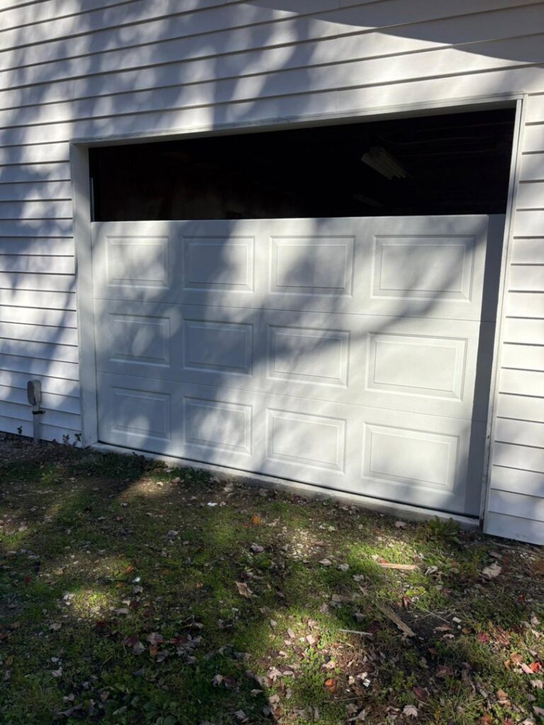 A garage door replacement in progress on a residential home by Lenny's Garage Door in Louisville, KY.
