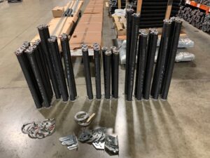 A garage door replacement in progress with new panels on the ground by CHS Garage Repair of Seattle, WA.