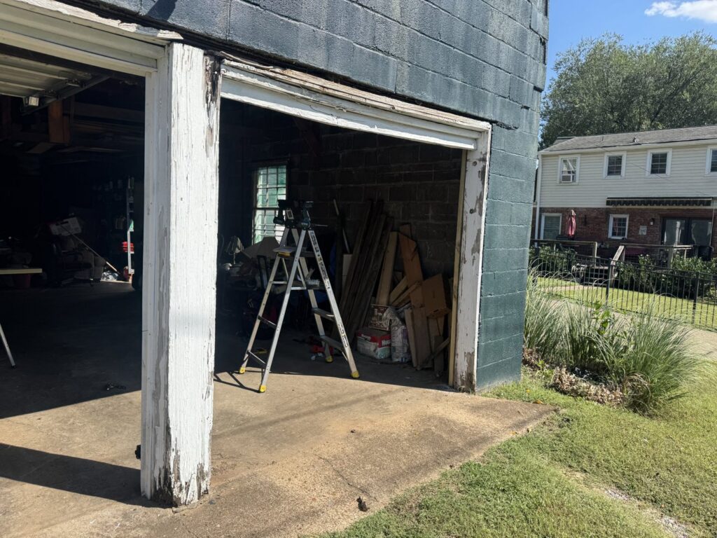 An open garage door with a ladder inside, indicating a garage door replacement or repair in progress by Swift Garage Door in Nashville, TN.