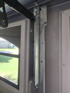 Close-up of a garage door roller and track system being serviced by American Overhead Door in Madison, AL