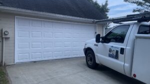 A service truck from The Birmingham Man Garage Doors at a residential property for a garage door service call in Birmingham, AL.