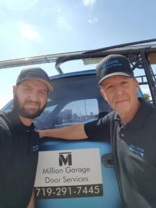The Million Garage Door Services team taking a selfie next to their branded service truck in Colorado Springs, CO.