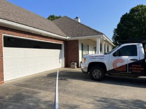 A Geaux Overhead Door service truck parked at a residential home during a garage door installation or repair in West Monroe, LA.