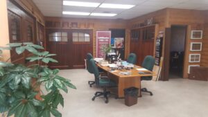 Interior view of the garage door showroom displaying various wooden door samples at Geiszler Garage Door in Milwaukee, WI.