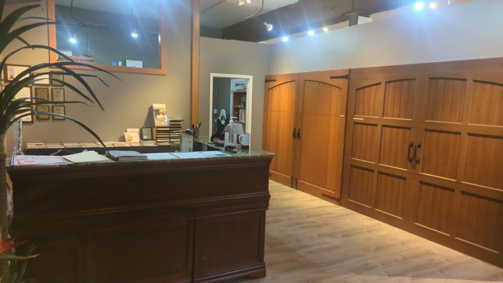 The reception area of the Rainier Garage Door showroom, displaying various garage door styles in Bellevue, WA.