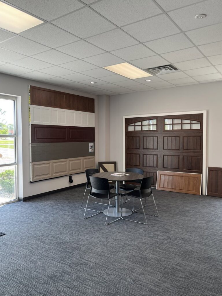 An interior showroom displaying various garage door samples and styles at Madison Overhead Garage Door Services in Madison, WI.