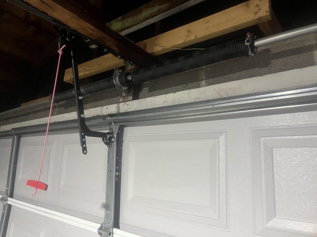 Close-up of a garage door spring and track system installed by The Region's Garage Door Repair in Hammond, IN.