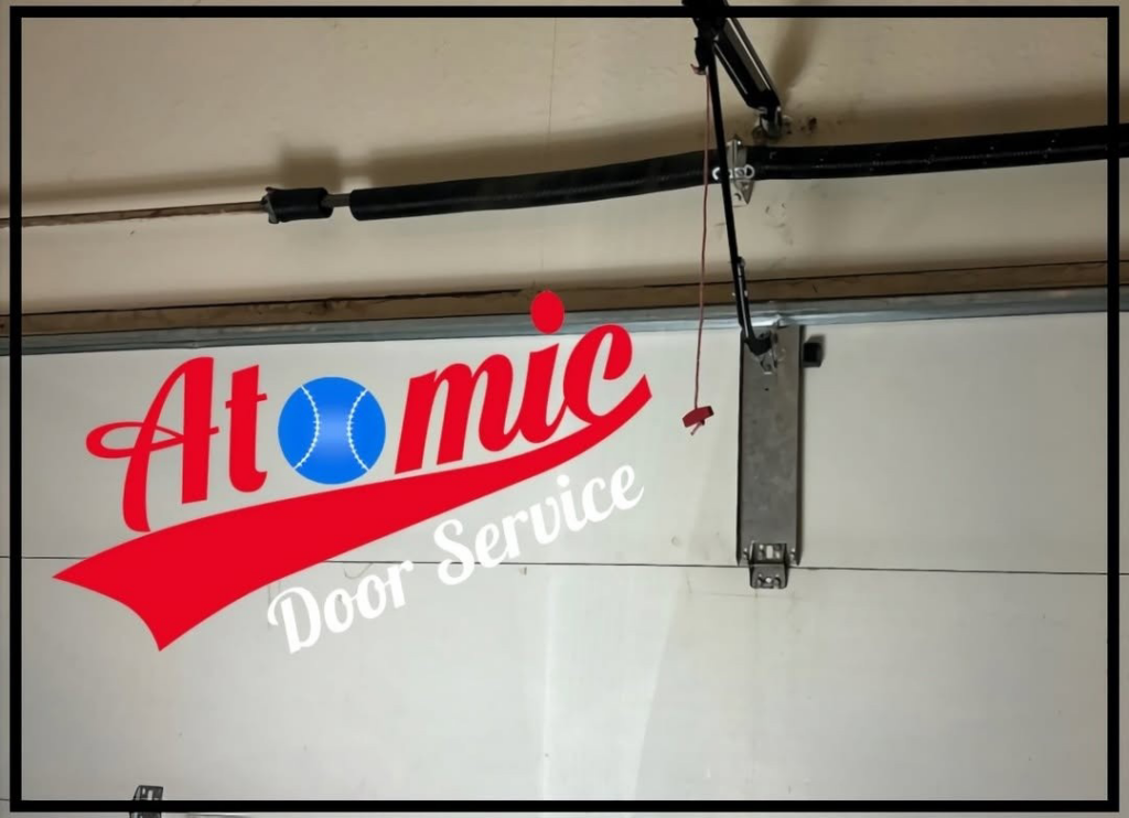 Close-up of a garage door spring and opener mechanism, showcasing the work of Atomic Door Service in Tulsa, OK.