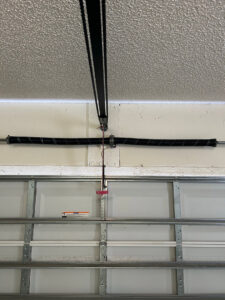 Interior view of garage door springs and tracks, showing components serviced by Chase Door Systems in Summerville, SC.
