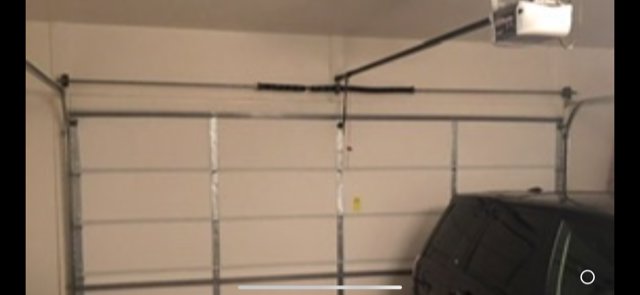 The interior view of garage door springs and tracks, showing a repair or maintenance job by Fix It Now Garage Doors.com in Tempe, AZ.