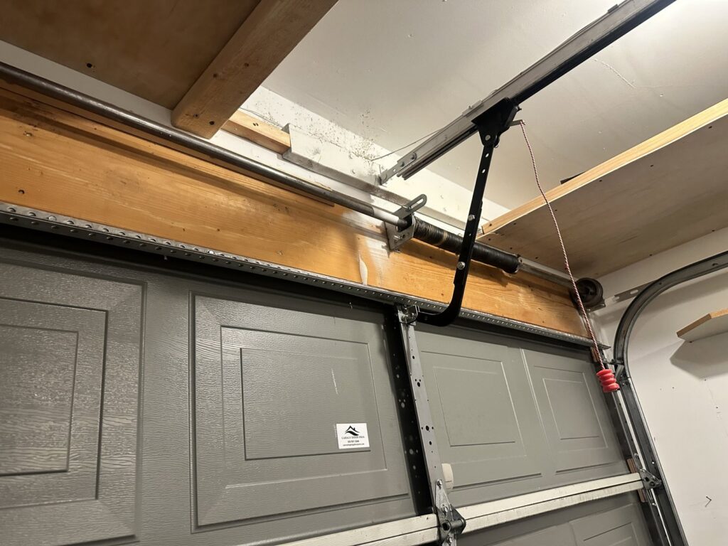 Close-up of garage door springs and tracks, showing repair or installation work by Colorado Garage Door Pro's in Denver, CO