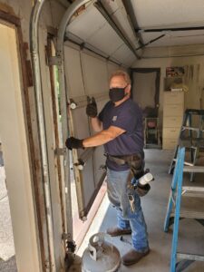 A garage door technician giving a thumbs up during a job by Garage Door Specialists Of Oklahoma Inc. in Oklahoma City, OK