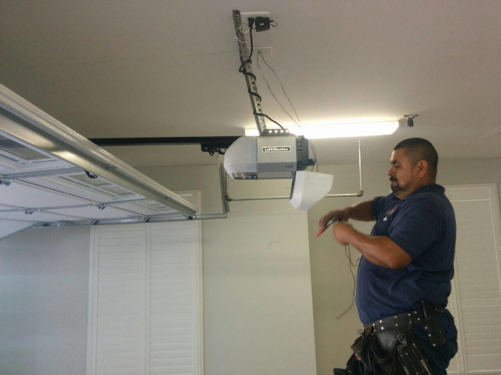 A garage door technician repairing an automatic opener system for Garage Door Fishers in Fishers, IN