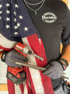 A Precision Garage Door Service technician holding tools for garage door repair in Lafayette, LA.