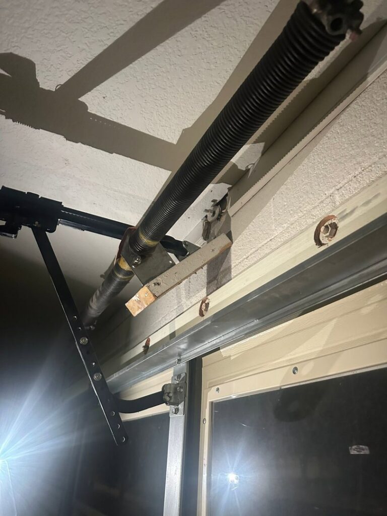 Close-up of a garage door torsion spring, showing a common repair or replacement service by Central Garage Door Repair LLC in Glendale, AZ.