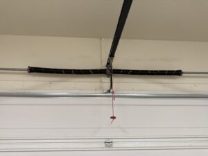 A close-up of a garage door torsion spring system, ready for repair or replacement by MGG Garage Door Service in San Tan Valley, AZ