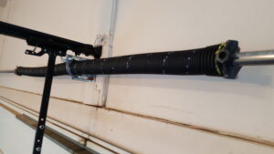 A close-up view of a garage door torsion spring, indicating replacement or repair work by Az Garage Door in Phoenix, AZ.