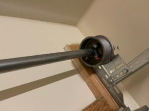 A close-up view of a garage door torsion spring system, showing components installed by Swift Garage Door in Nashville, TN.