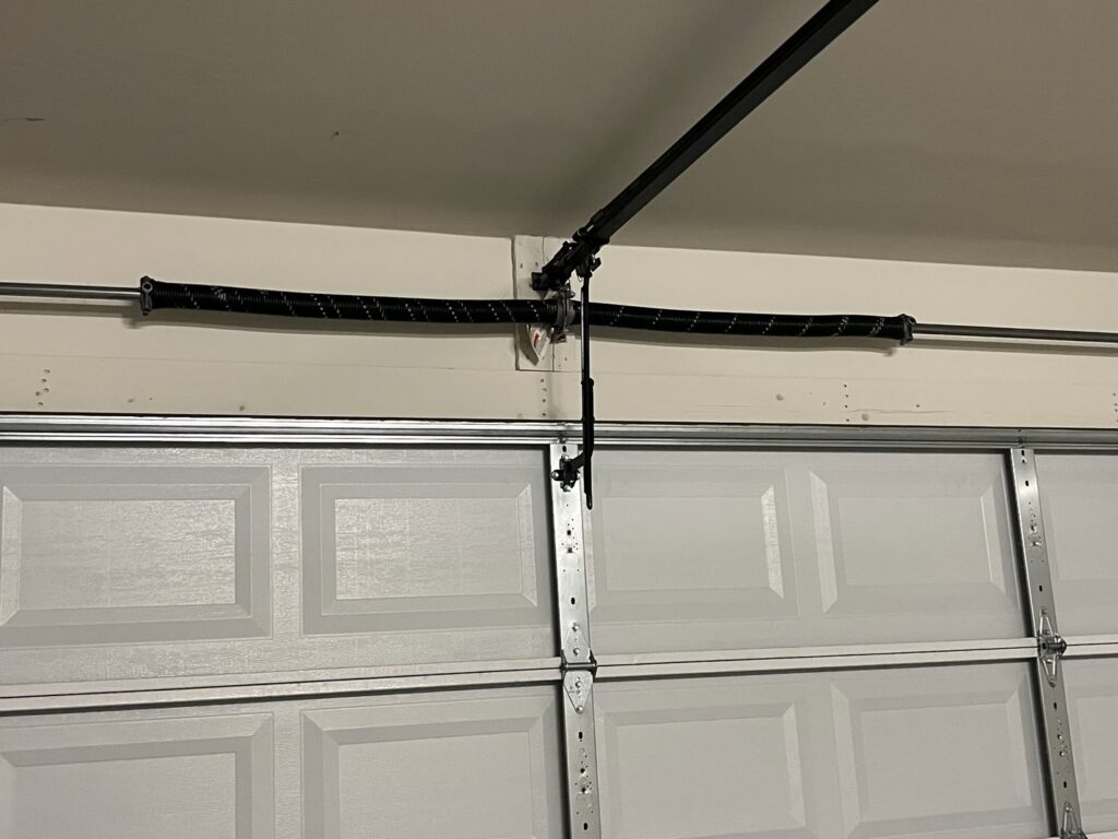 A close-up view of a garage door torsion spring system, a common repair for Tucson Garage Door Doc in Tucson, AZ.