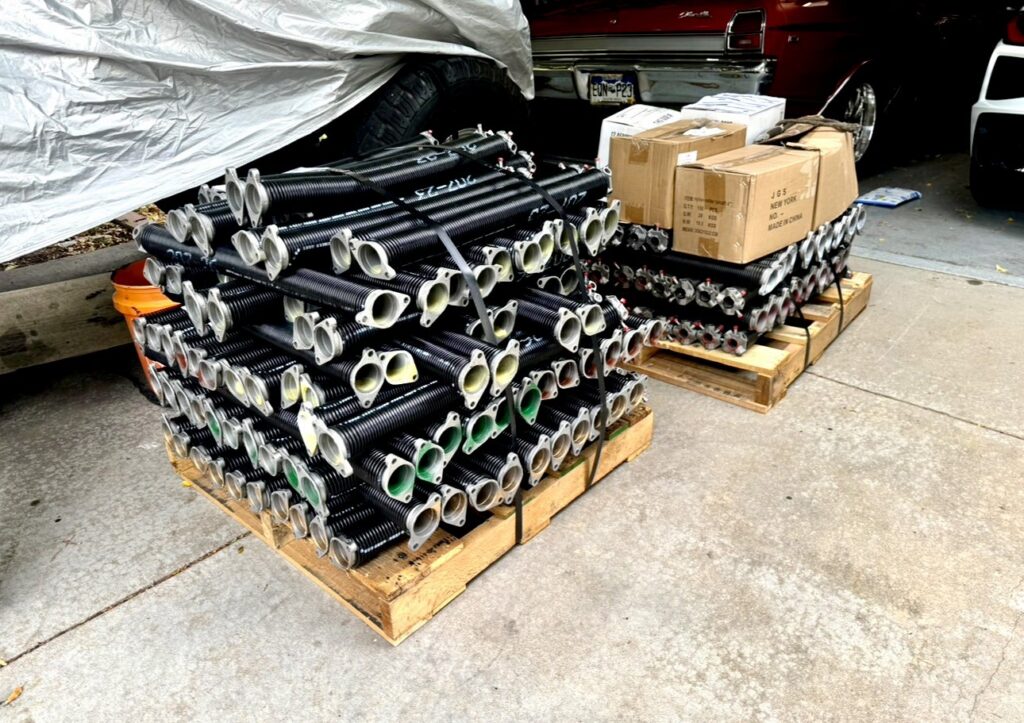 Pallets stacked with new garage door torsion springs, ready for service by Lion Heart Garage Doors in Thornton, CO.