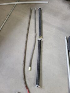 Various garage door torsion springs laid out for replacement or repair by Gryffin Garage Door in Chandler, AZ