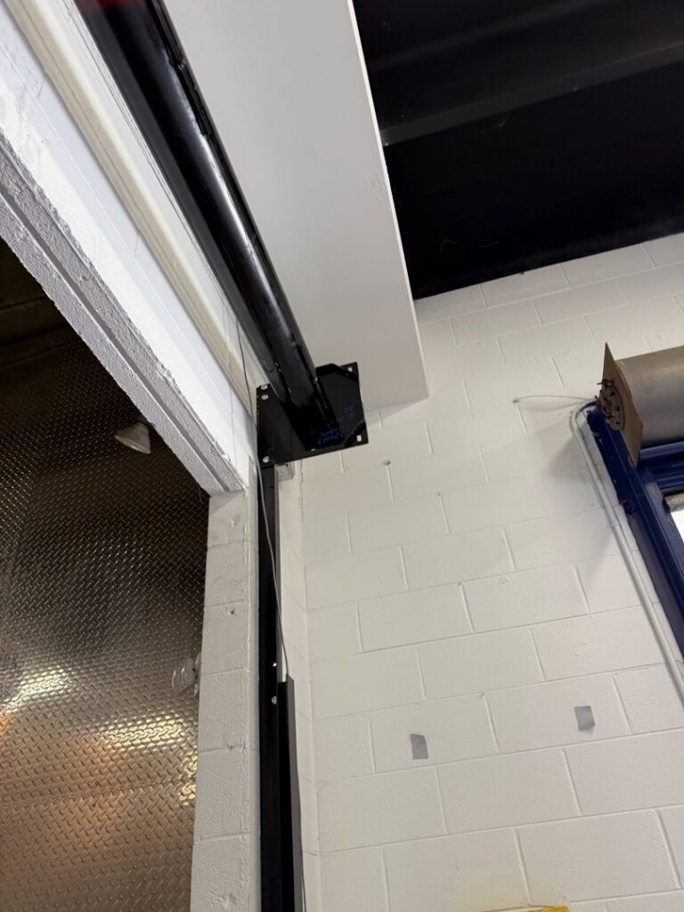 A close-up of a garage door track and roller system being installed by Universal Overhead And Garage Doors in Baltimore, MD.