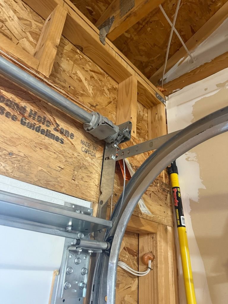 A garage door track and torsion spring assembly being installed or repaired by Colorado Garage Door Guy in Aurora, CO.