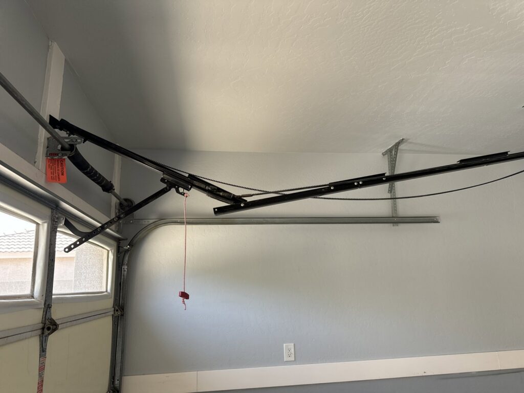 Interior view of garage door tracks, torsion springs, and opener rail system serviced by MGG Garage Door Service in San Tan Valley, AZ