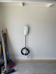 An electric vehicle charging station installed on a garage wall by R&M Electric LLC in Gilbert, AZ.