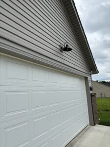 A stylish exterior light fixture installed above a garage door by TCB Electric LLC in Elizabethtown, KY.