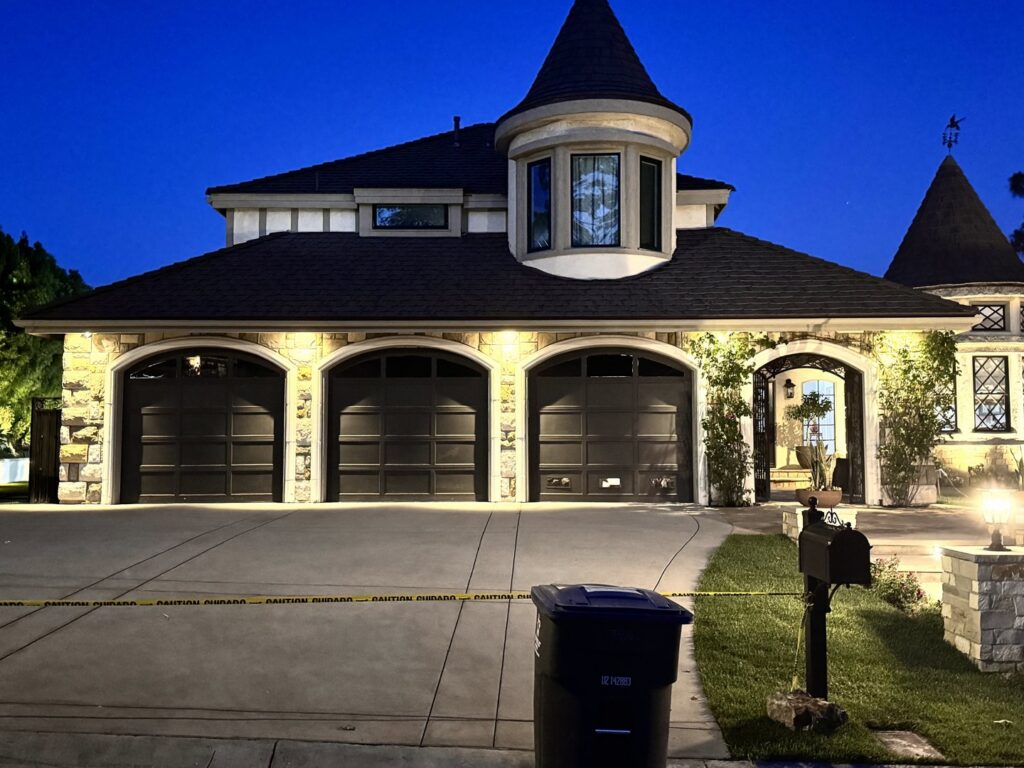 A house with garage doors and subtle, elegant exterior lighting, installed by GL3 Luxury Lighting in Anaheim, CA.