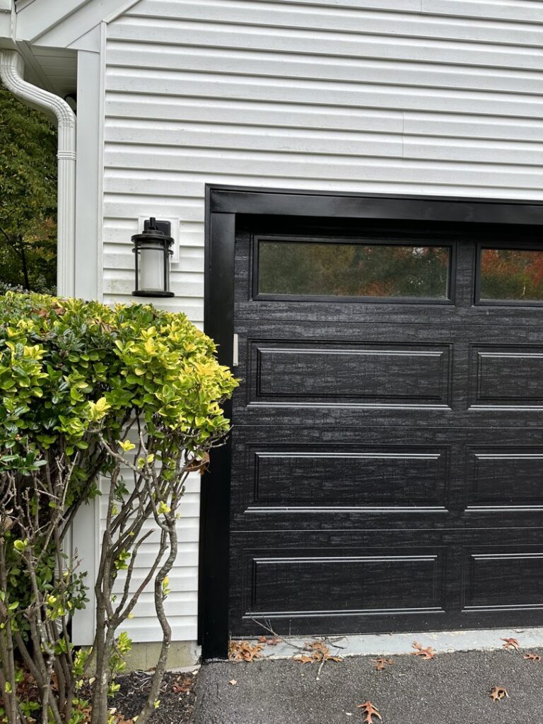 An outdoor wall lantern installed next to a garage door by GBE. Lectrical LLC in Gaithersburg, MD