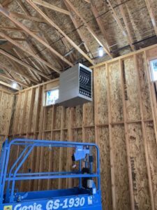 A ceiling-mounted garage heater installed in a new construction by Finney Heating and Cooling LLC in Post Falls, ID.