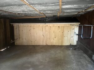 Repaired garage interior with new wood paneling, likely after wildlife damage, by Stellar Wildlife Solutions in Cottage Grove, MN.