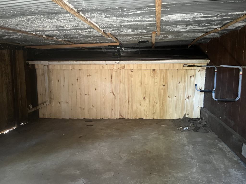 Repaired garage interior with new wood paneling, likely after wildlife damage, by Stellar Wildlife Solutions in Cottage Grove, MN.