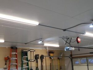 Garage ceiling with conduit, fluorescent, and recessed lighting installations by Decatur Electrician Now in Decatur, AL.