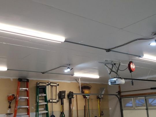 Garage ceiling with conduit, fluorescent, and recessed lighting installations by Decatur Electrician Now in Decatur, AL.