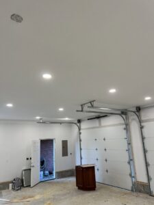 A garage with new recessed lighting and an electrical panel installed by Ace Electrical Services LLC in Owensboro, KY.