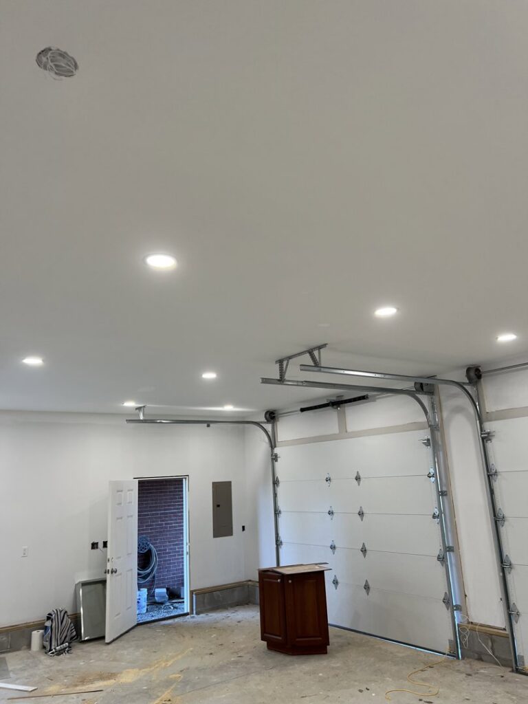 A garage with new recessed lighting and an electrical panel installed by Ace Electrical Services LLC in Owensboro, KY.