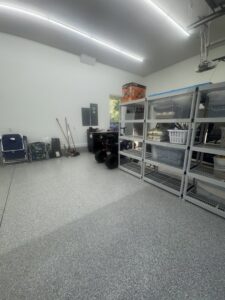 Bright overhead lighting and an electrical panel in a garage by All Service Electric in Jacksonville, FL.