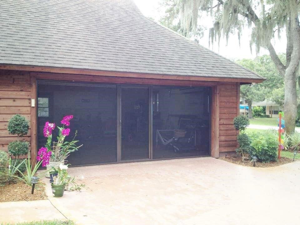 Three dark garage screen doors installed on a wooden garage by Access Garage Doors-Chattanooga, TN